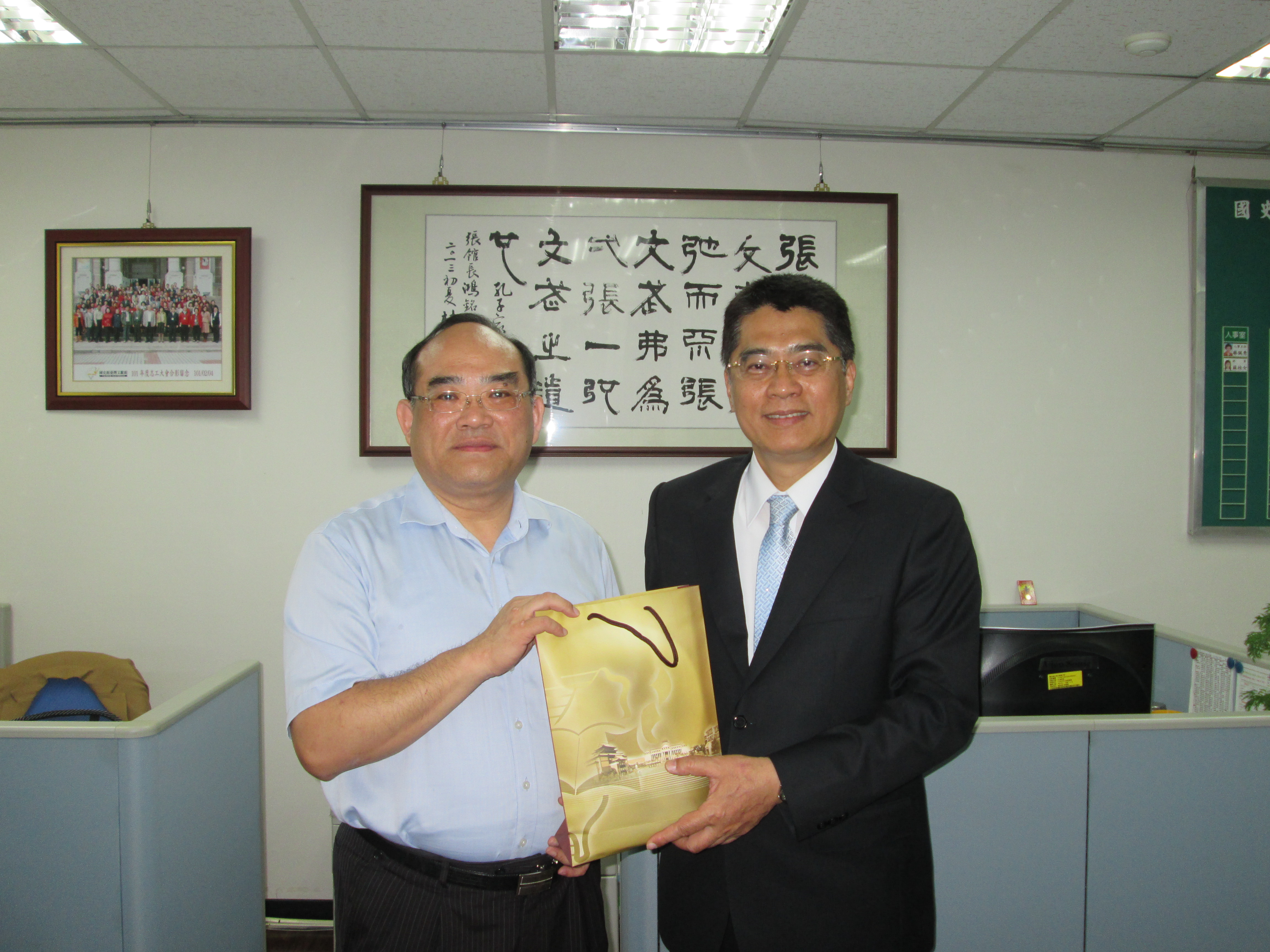 圖4：張館長（左）致贈賈鴻奎主任（右）本館數位典藏宣導品