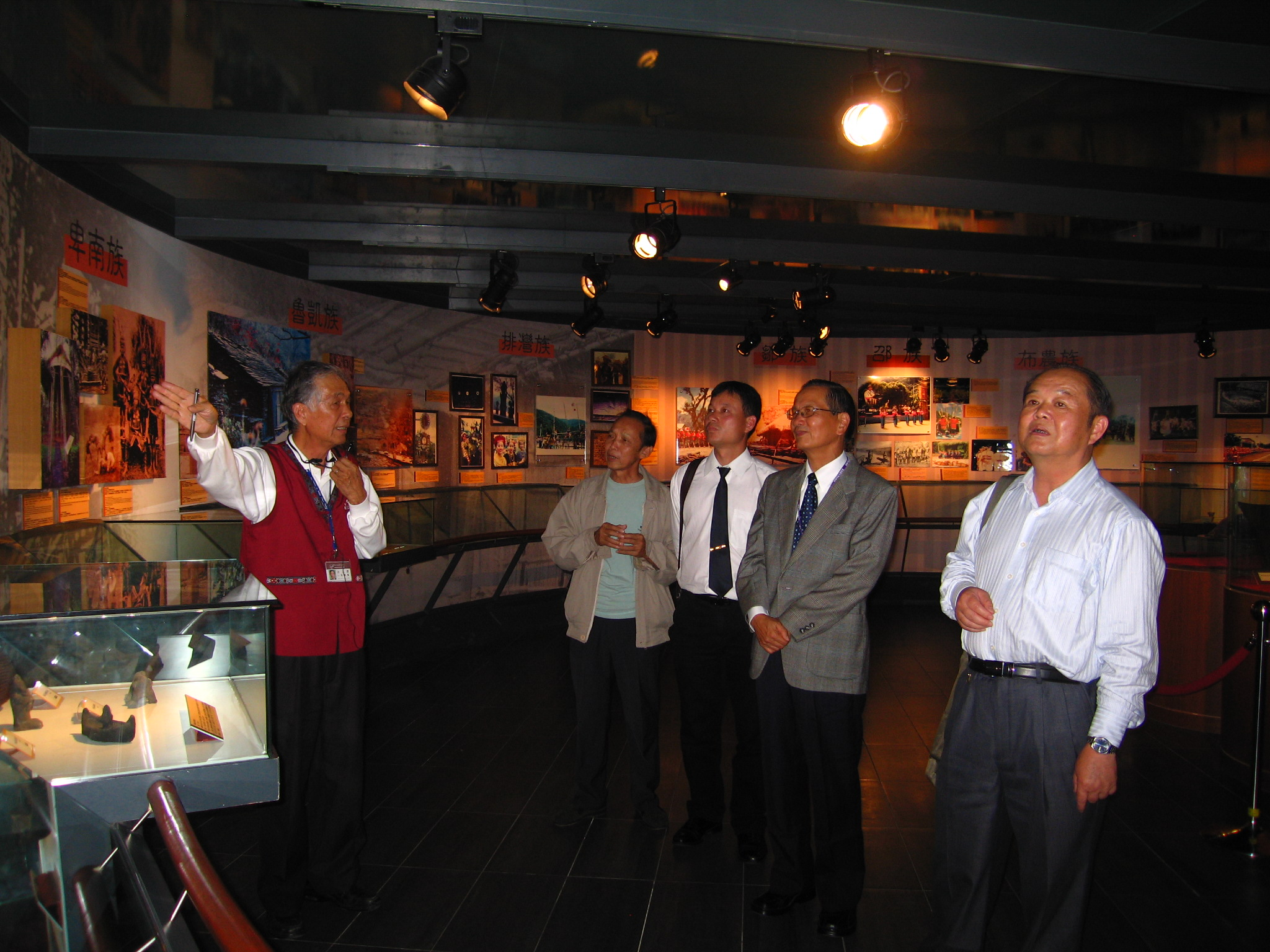 志工隊張總幹事慶龍(左1)導覽本館展場